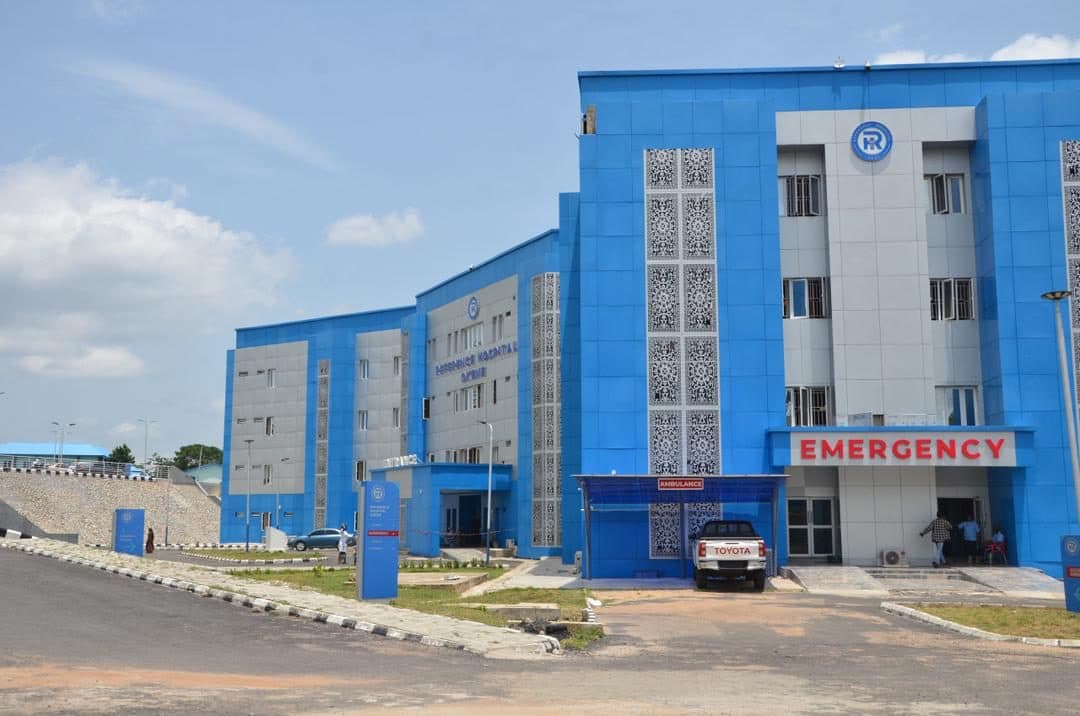 The Reference Hospital, Okene — a blue multi-storey hospital with an emergency wing